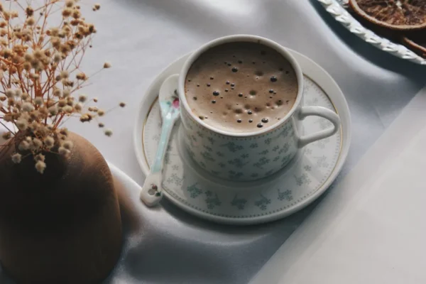 Open book and a cup of coffee on a quiet morning table