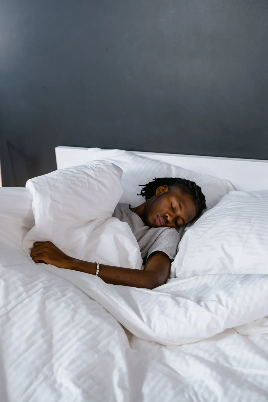 Man sleeping deeply on white bedding